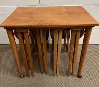 A teak side table with four folding side tables nested inside (H56cm W62cm D42cm)