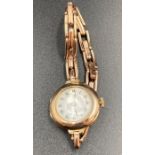 A 9ct gold Ladies watch with enamel face.