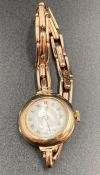 A 9ct gold Ladies watch with enamel face.