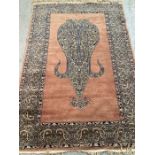 A brown ground wool rug with central medallion and geometric border red and blues (130cm x 210cm)