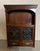 A mahogany wall hanging two door stained glass cupboard with two drawers and bookcase to top (
