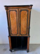 A music cabinet with panelled doors opening to shelves and divers to base (H120cm W56cm D37cm)