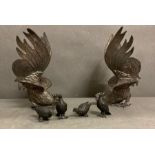 A Pair of white metal fighting cockerels and four bronze style partridge.