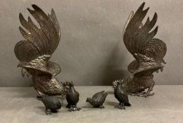 A Pair of white metal fighting cockerels and four bronze style partridge.