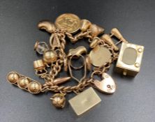 A 9ct gold charm bracelet with a number of charms including an 1896 sovereign.