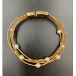 An 18ct gold Mappin & Webb bracelet with individual pearl decoration