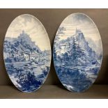 A pair of rare oval blue and white, mountain scenes wall plaques