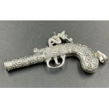 A silver whistle in the form of a gun