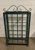 A green painted free standing wrought iron wine rack