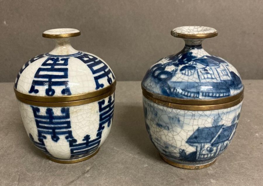 Two hand painted Chinese lidded pots with brass banding