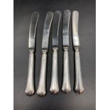 A set of five silver handled butter knives, hallmarked for Sheffield 1918 by Yates Brothers