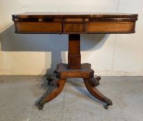 A mahogany fold over card table on out swept legs with brass paw feet and castors (H74cm W92cm
