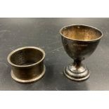 A hallmarked silver egg cup and a napkin ring