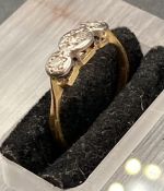 A three stone antique diamond ring on an 18ct yellow gold setting (Size H 1/2)