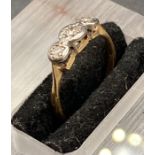 A three stone antique diamond ring on an 18ct yellow gold setting (Size H 1/2)