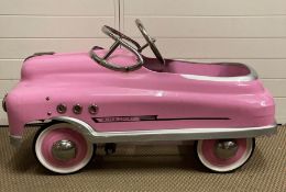 A pink metal 1950's style pink super sport comet pedal car