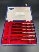 A Boxed set of silver handled butter knives.