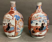 A pair of Imari pattern bottle vases