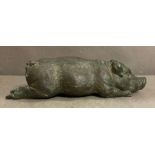 A small vintage decorative bronze of a lying pig
