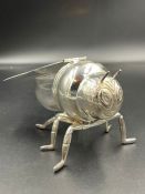 A silver plate and glass h0ney jar in the form of a bee.