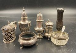 A selection of hallmarked silver cruets, in various styles and makers along with a single stem vase