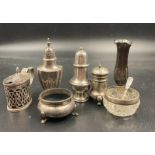 A selection of hallmarked silver cruets, in various styles and makers along with a single stem vase