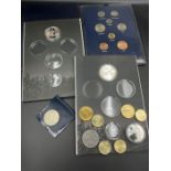 A small selection of collectable coins, Coins of Great Britain pack and medallions.