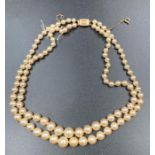 A double string pearl necklace with a 9ct gold clasp.