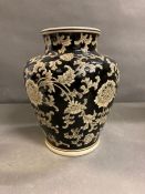 An India Jane of London black painted vase with floral motif