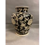 An India Jane of London black painted vase with floral motif