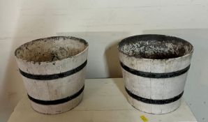 A pair of resin planters in the form of a barrel