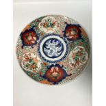 A Japanese Imari charger with roundels of flora and fauna (Dia33cm)