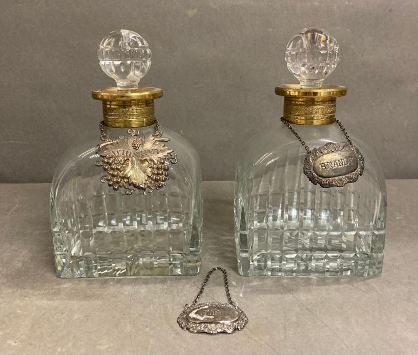 Two French crystal decanters with gilded collars and a hallmarked port decanter tag