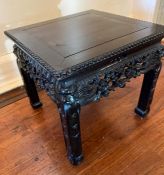 An 19th century carved Chinese table, possibly Qing dynasty (H35cm Sq37cm)
