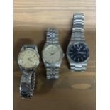 A selection of wristwatches to include an automatic watch with a blue face with date and day of week