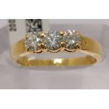 An 18ct yellow gold diamond trilogy ring, approx 0.75cts, stamped 750, approx size N
