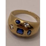 Yellow gold ring with blue and clear stones, marked 09. approx size R, approx gross weight 4.7g