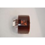 A brown / dark orange plastic wristwatch stamped Emporio Armani