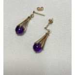 A pair of 9ct yellow gold lantern shaped amethyst bead stud earrings, hallmarked 9ct to stem,