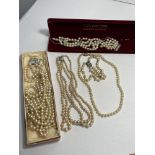 A group of vintage pearl/pearlized necklaces and bracelet, all in need of repair, some with boxes