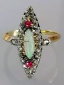 An Edwardian opal, ruby and diamond ring in a yellow metal cage setting, size O