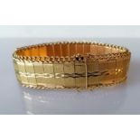 A vintage gold articulated bracelet with textured links and curb-link chain edge, 19 cm, test for 14