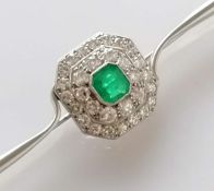An Art Deco emerald and diamond platinum brooch, the emerald 5mm x 6mm, thirty-one round-cut diamond