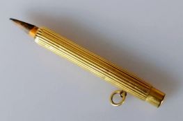 A yellow gold pencil holder with fluted decoration, unmarked, tests for 18ct gold, 68mm, 12g