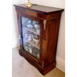 A Victorian walnut display cabinet with glazed door, shelved interior, ormolu mounts and painted flo