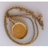An Edwardian gold half sovereign, 1910, on a 9ct gold mount and chain, hallmarked, chain damaged, 9.