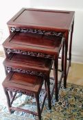 A Chinese hardwood nest of four tables with carved decoration, 64 h x 51 w x 35 d cm