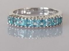 An 18ct white gold blue topaz ring, the nine princess-cut stones in a channel setting, size L, Cypru