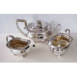 A Victorian silver three-piece tea service with acanthus leaf and shell scroll decoration on ball fe