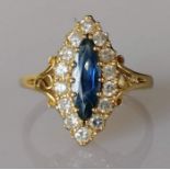 An 18ct yellow gold marquise-set sapphire and diamond ring, sapphire 13 x 5mm, the fourteen round-cu